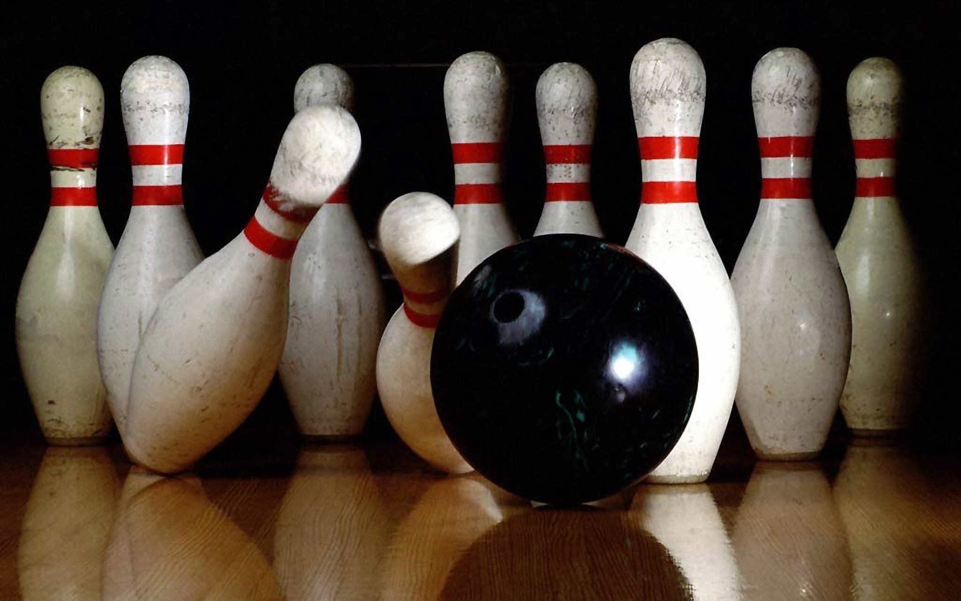 Black bowling ball roll the pins ppt backgrounds